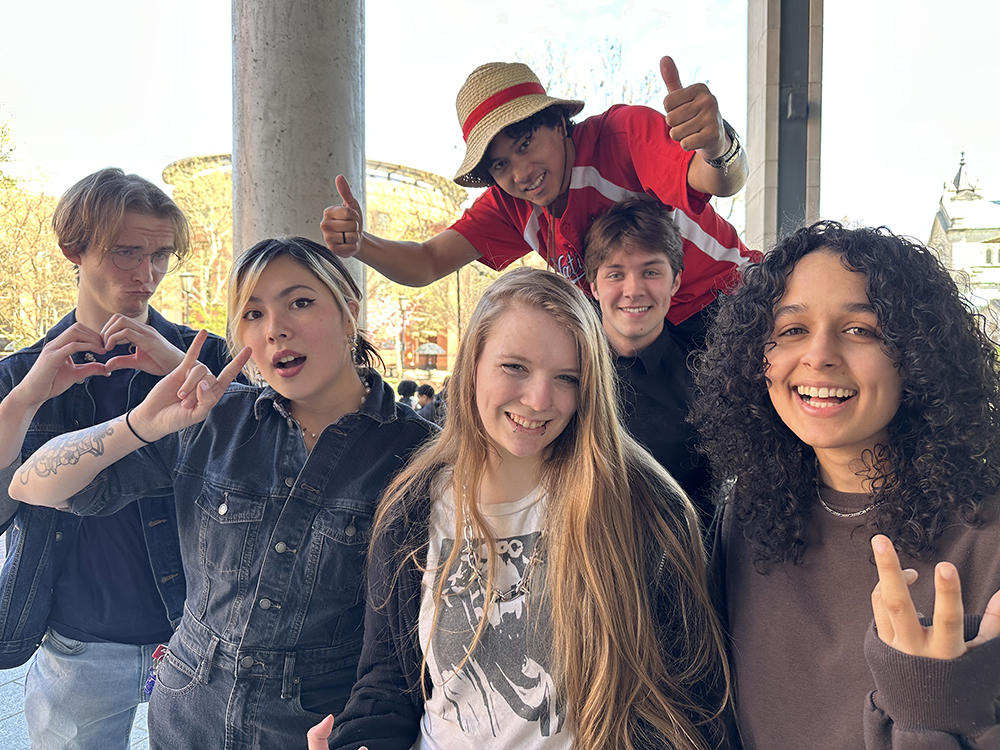 Winners of the 2026 contest pose in an informal photograph on the porch of Cabell Library